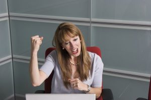 Female manager flexing muscles